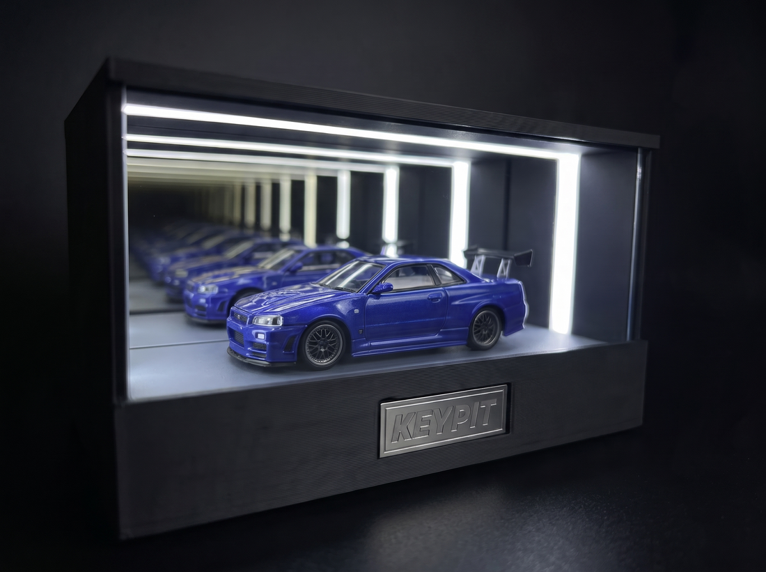 KP Design Infinity Garage LED display case lighting a blue diecast car in a dark studio