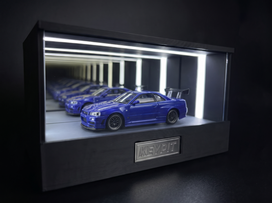 KP Design Infinity Garage LED display case lighting a blue diecast car in a dark studio