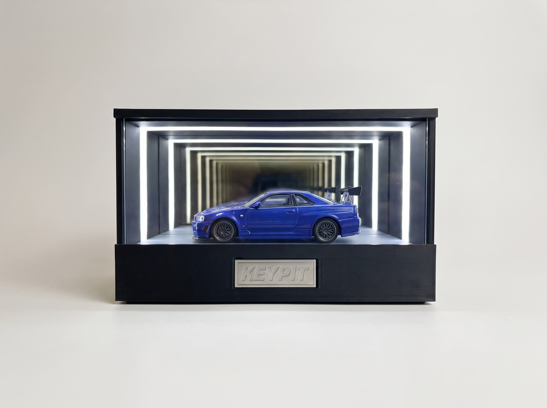 KP Design Infinity Garage displaying a loose blue 1:64 diecast car, front view