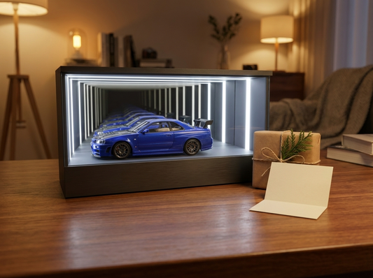 KP Design Infinity Garage LED display case presented as a Christmas gift beside a wrapped box and gift card on a warm wood desk