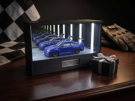 KP Design Infinity Garage LED display case presented as a motorsport-fan gift beside a wrapped box, checkered flag and driving gloves