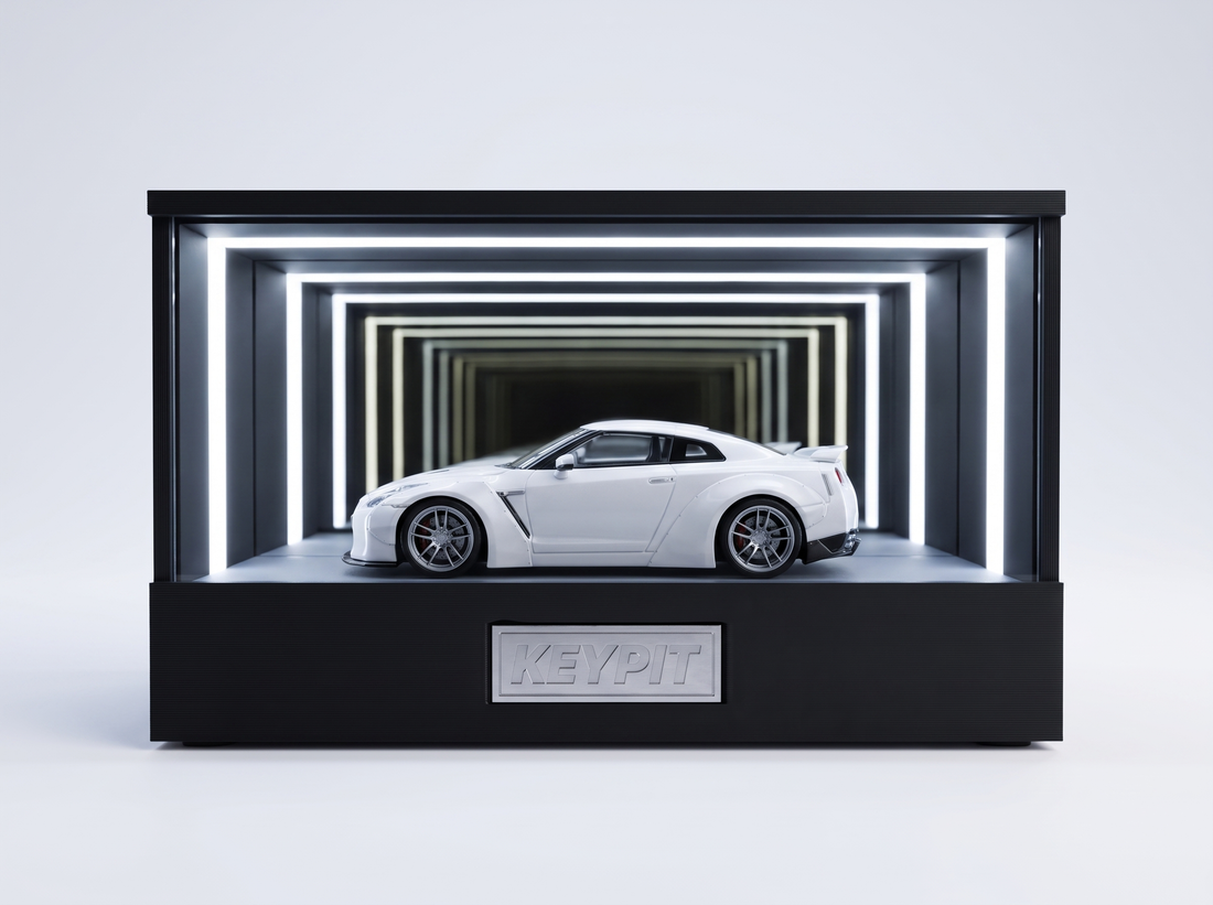 A white Nissan GT-R R35 1:64 diecast displayed in the lit KP Design Infinity Garage case