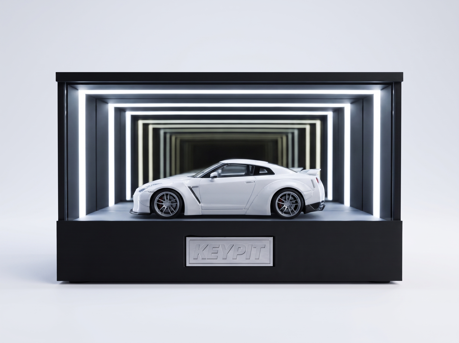 A white Nissan GT-R R35 1:64 diecast displayed in the lit KP Design Infinity Garage case