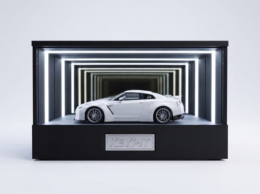A white Nissan GT-R R35 1:64 diecast displayed in the lit KP Design Infinity Garage case