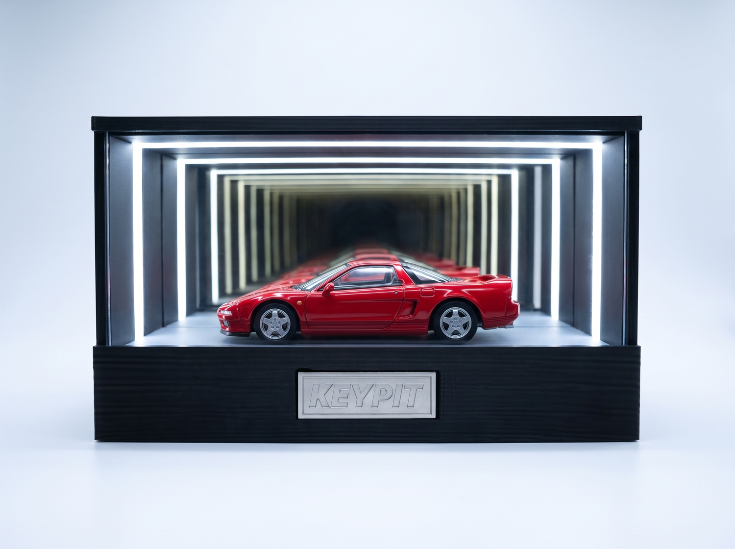 A red first-generation Honda NSX NA1 1:64 diecast displayed in the lit KP Design Infinity Garage case