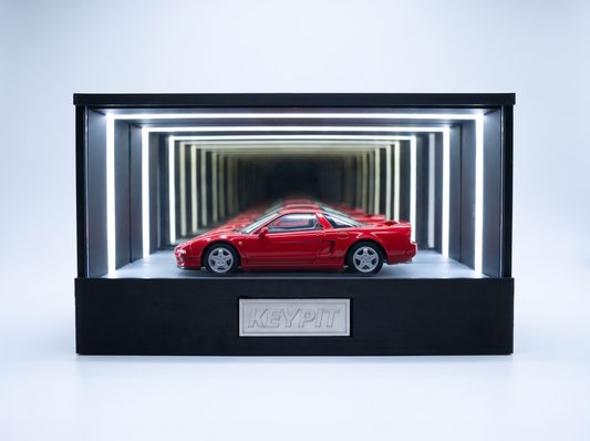 A red first-generation Honda NSX NA1 1:64 diecast displayed in the lit KP Design Infinity Garage case
