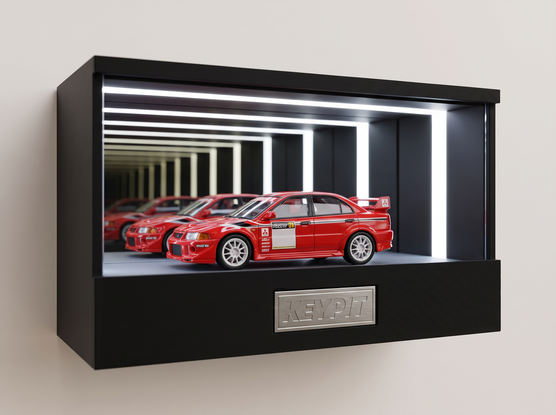 A red Mitsubishi Lancer Evo VI rally sedan 1:64 diecast with rear wing displayed in the lit KP Design Infinity Garage case