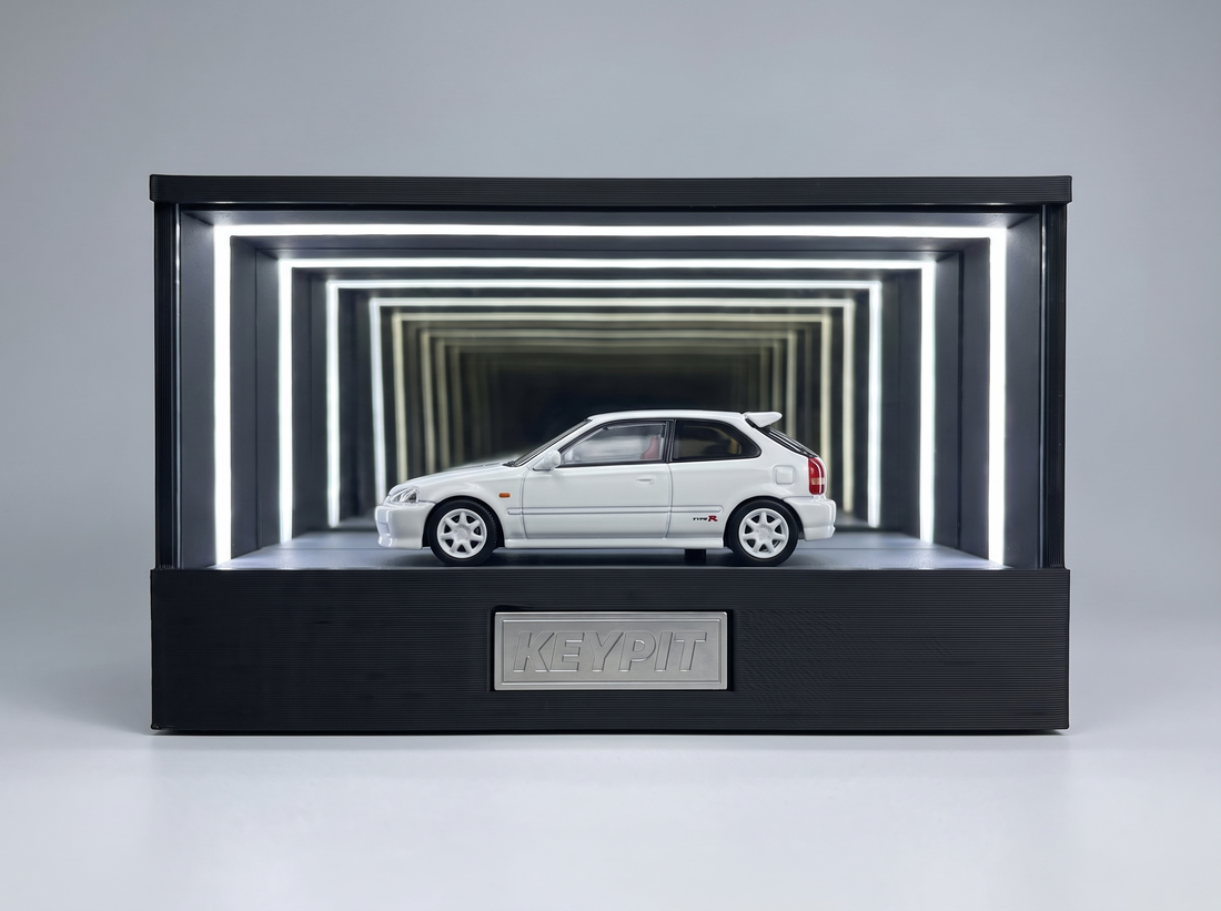 A Championship White Honda Civic Type R EK9 1:64 diecast displayed in the lit KP Design Infinity Garage case