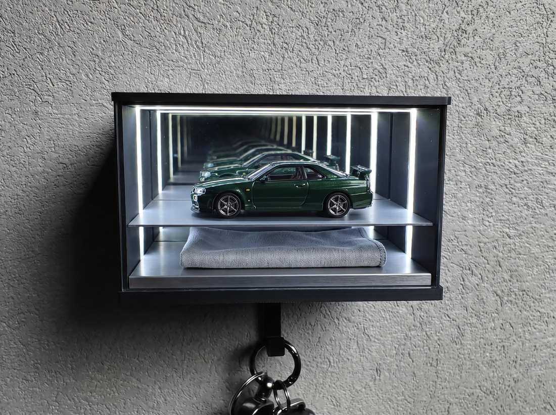 A 1:64 diecast car displayed inside a sealed lit case, protected from household dust