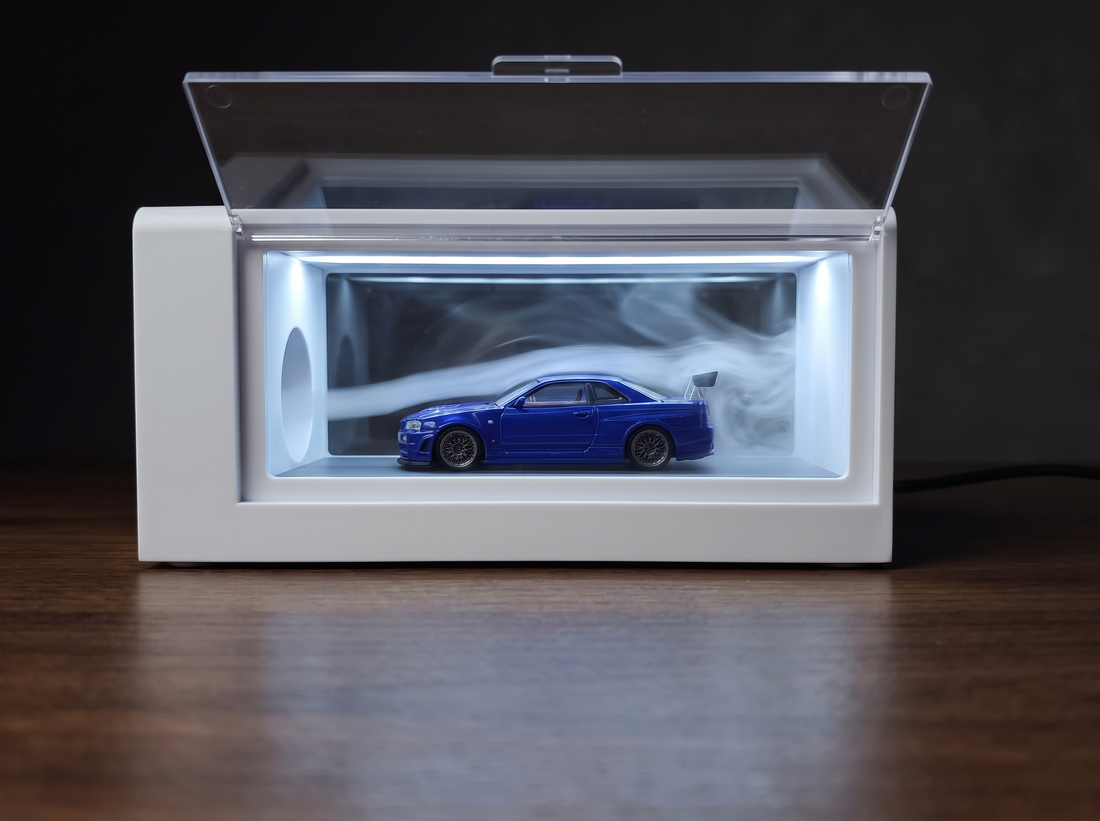 A blue 1:64 diecast car photographed under even lighting
