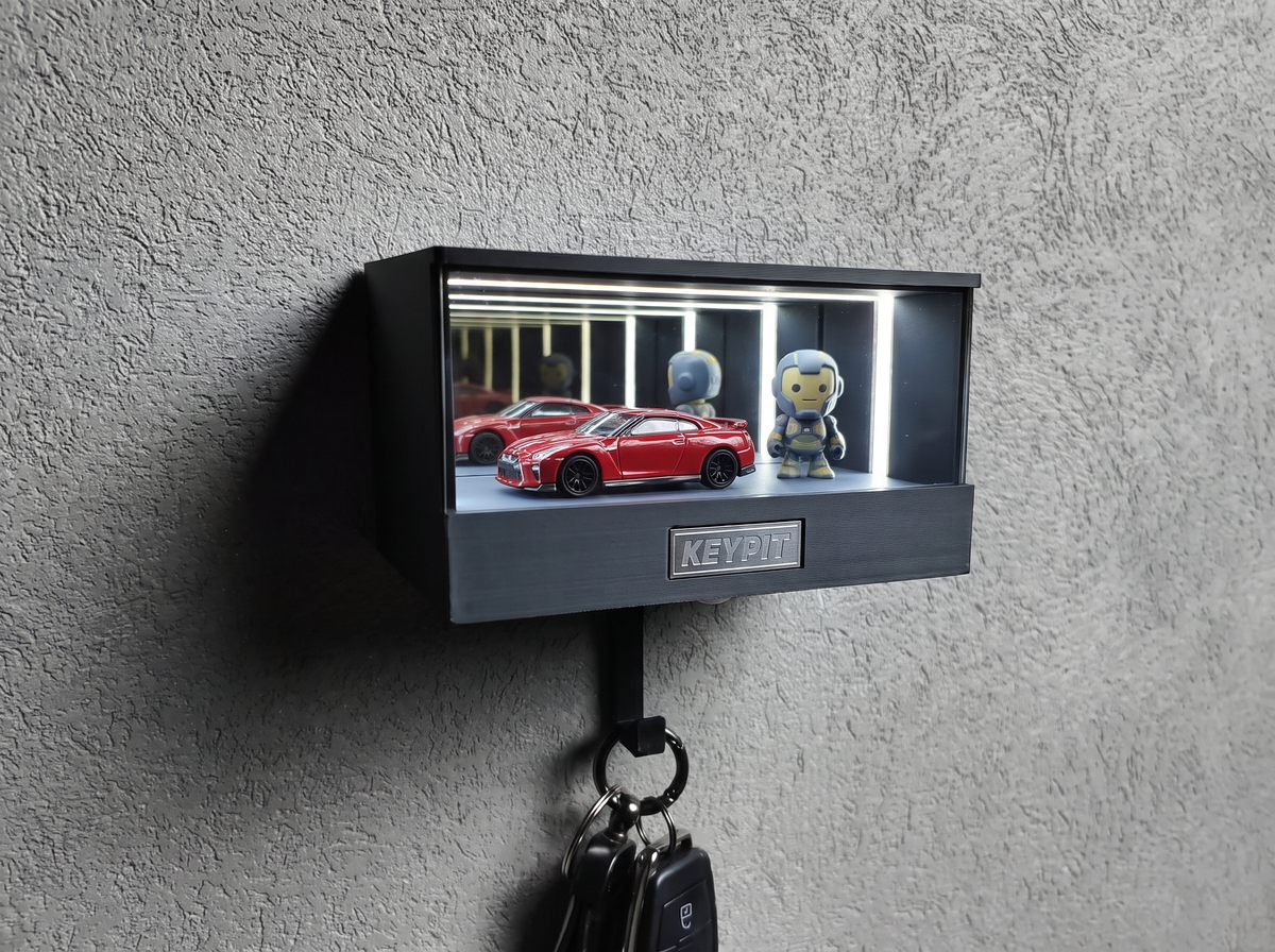 A lit collectibles display case holding a 1:64 diecast car and a small vinyl figure under neutral white 4000K LED light