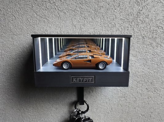 A single 1:64 diecast supercar displayed alone in a lit wall-mounted case, shown in side profile