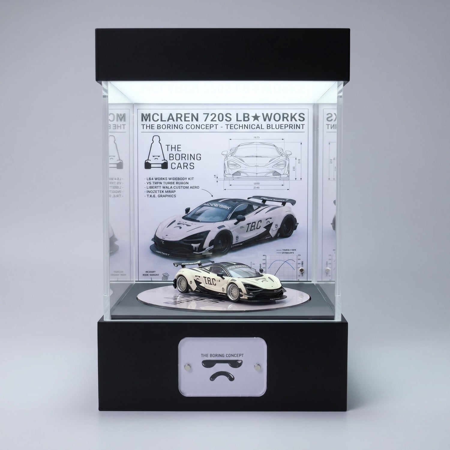 A white widebody McLaren 720S 1:64 in a lit KP Design Rotating Stage with a technical blueprint backdrop showing spec drawings and dimensions