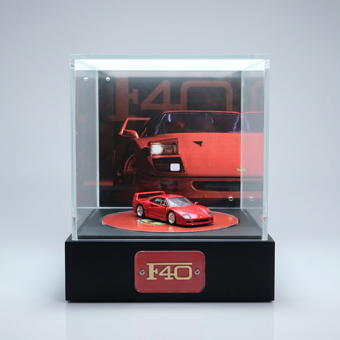A red Ferrari F40 1:64 lit alone in a KP Design display, showing how activated lighting makes a single car the focus