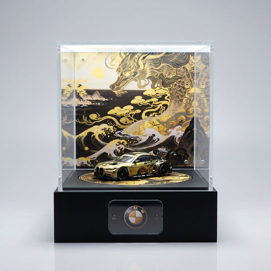 A gold and black BMW M4 GT 1:64 on a KP Design Rotating Stage with a plain BMW roundel nameplate on the base