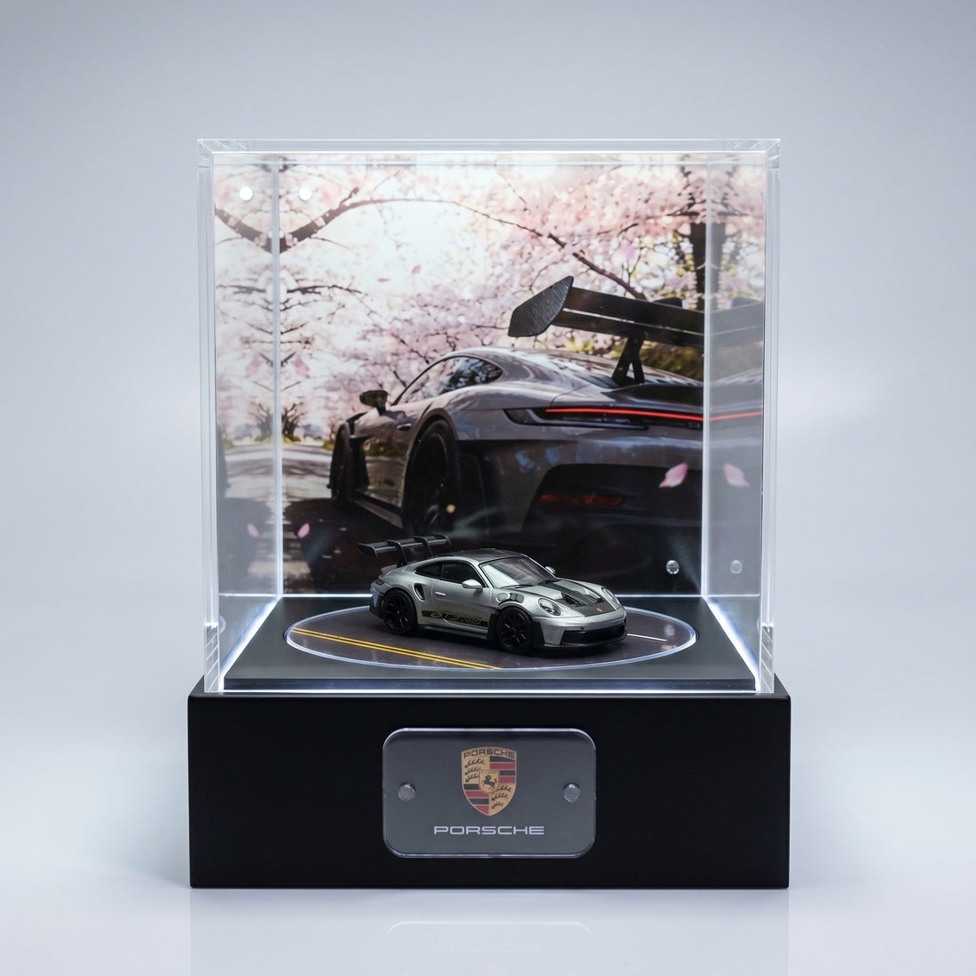A silver Porsche 911 GT3 RS 1:64 on a KP Design Rotating Stage where the floor disc continues the road markings from the backdrop scene