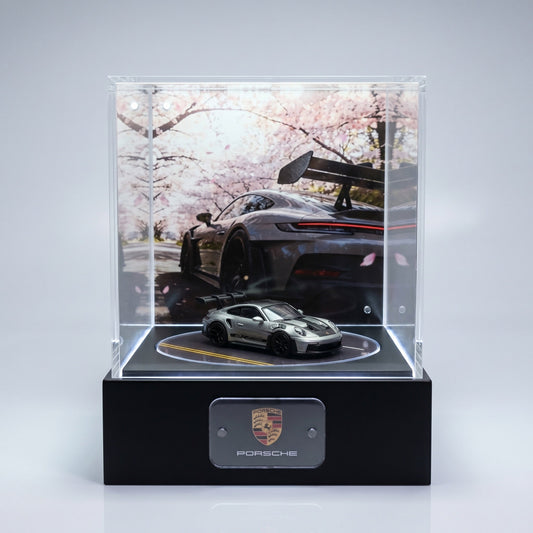 A single silver Porsche 911 GT3 RS 1:64 displayed alone in a lit KP Design Rotating Stage