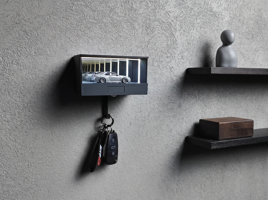 A lit wall-mounted display case holding one silver 1:64 car at eye level, with two sparse floating shelves beside it